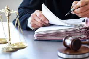 Scales of justice with judge gavel on table